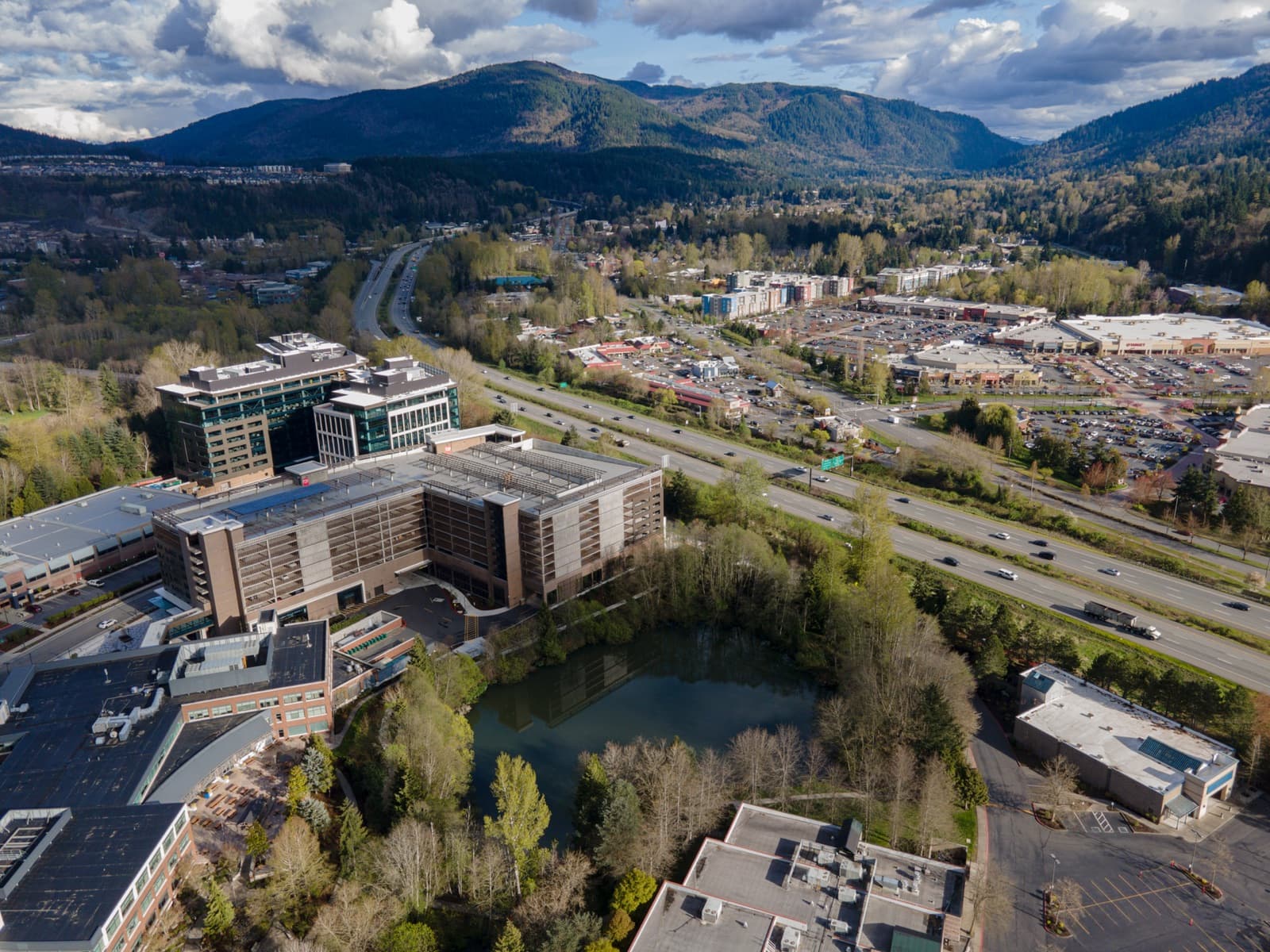 Aerial view of Issaquah along I-90 with the Issaquah Alps behind